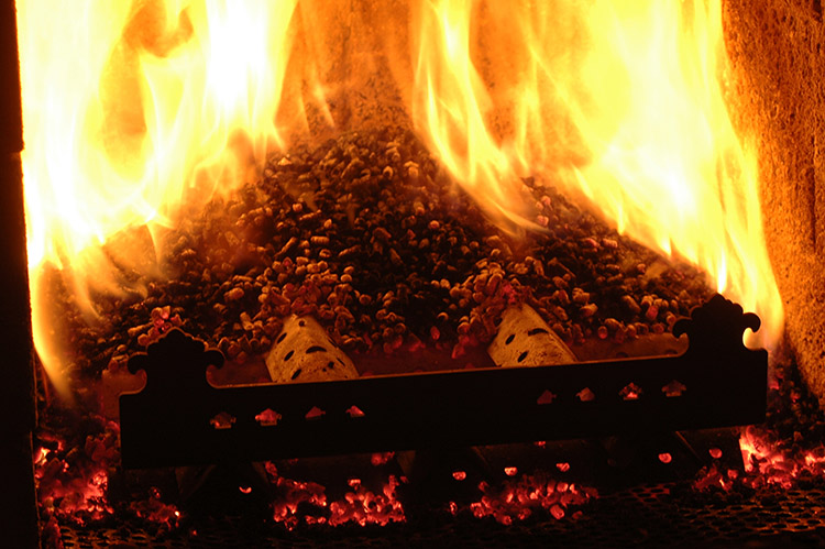 a picture of biomass pellets burning in the combustion chamber